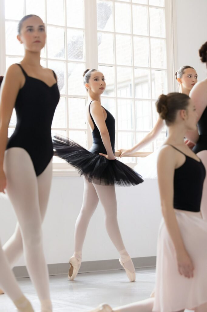 Ballet students in class at the barre, on-location photography for a dance school by Ashkan Image