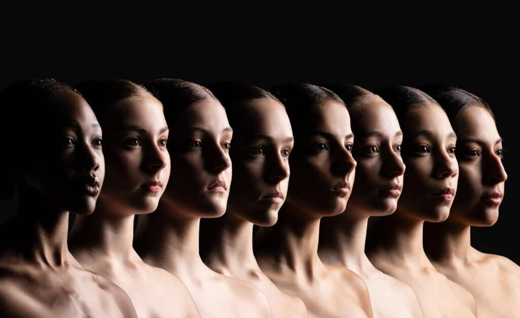 Profile portraits of eight company dancers in dramatic light, Houston dance company photography