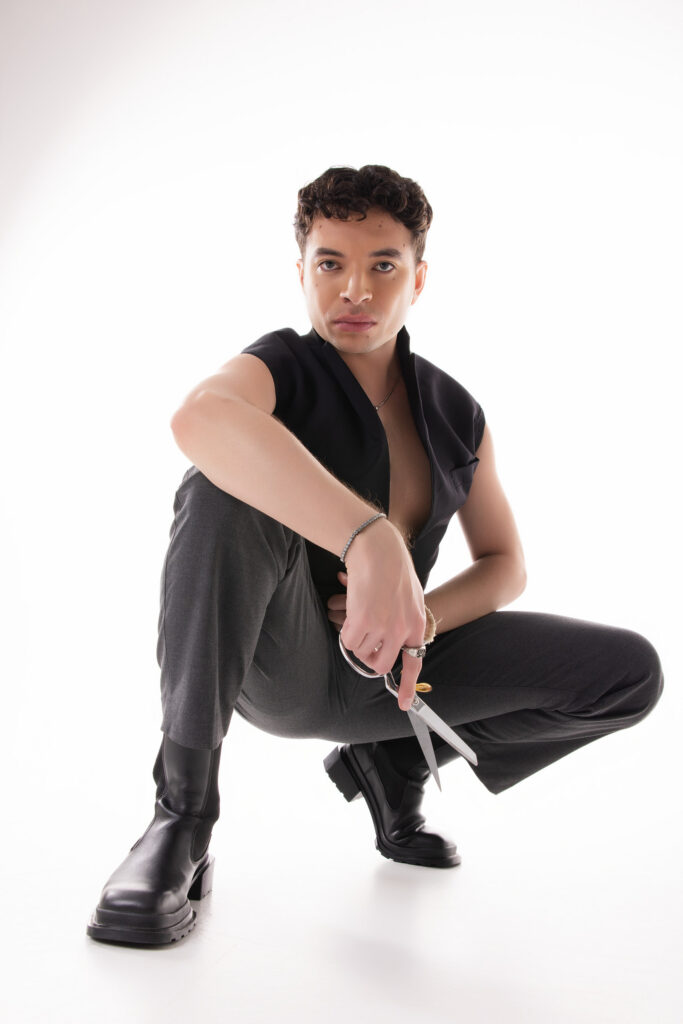 Personal branding photography in Houston, menswear portrait crouching with scissors, by Ashkan Image