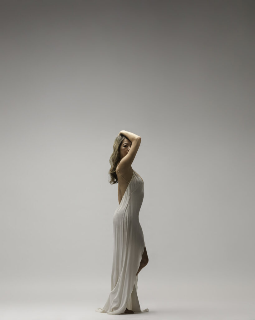 Personal branding photography in Houston, woman in an ivory slip gown in profile, by Ashkan Image