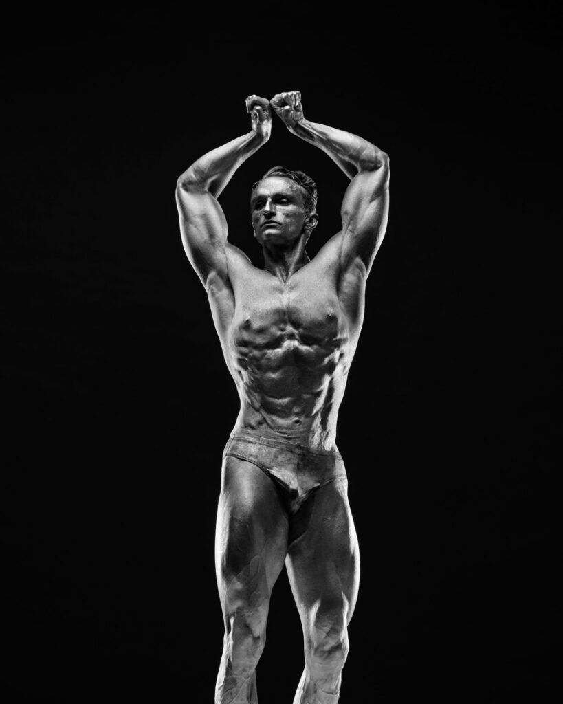 Houston fitness photography, black and white physique front pose with arms overhead, by Ashkan Image
