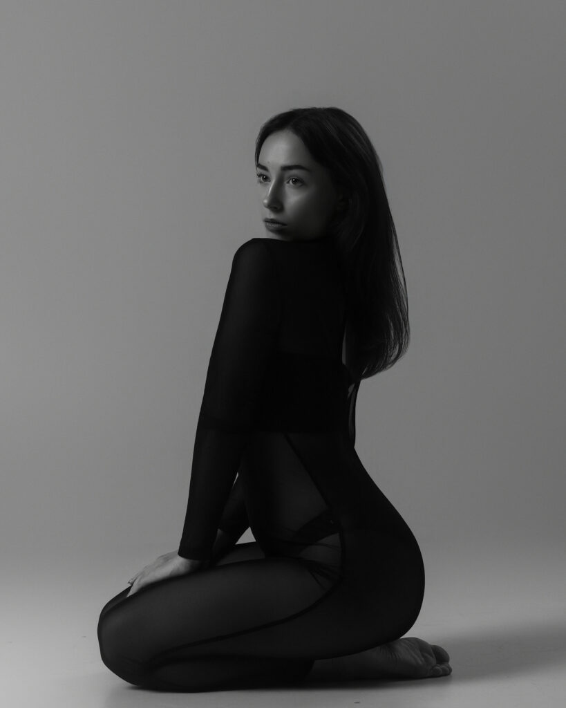 Seated profile portfolio image in black, Houston model photography