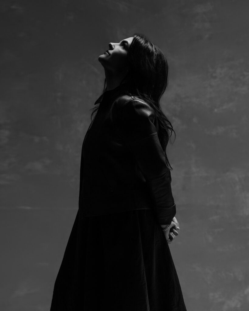Personal branding photography in Houston, black and white portrait of a woman looking up in a leather jacket, by Ashkan Image